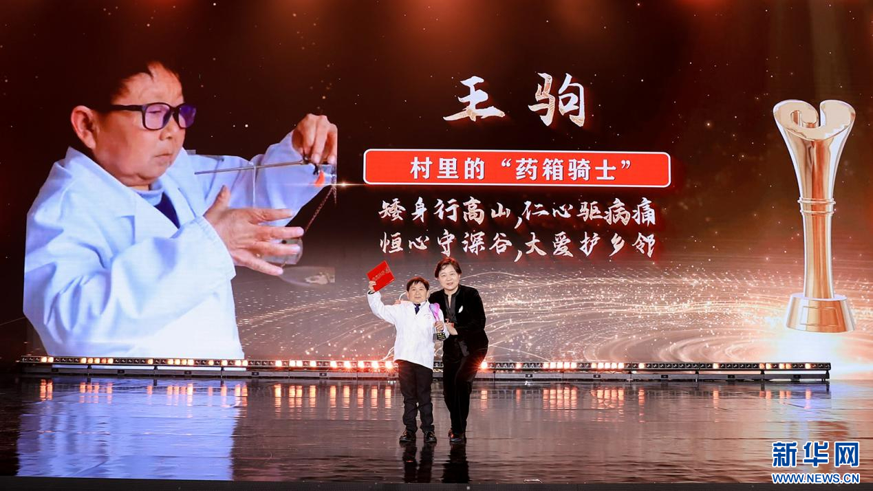 繆瑞蘭為村里的“藥箱騎士”王駒頒獎(jiǎng)（圖）